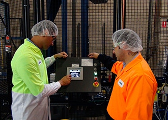 Employees examining the new CHEP Lantech SLA4000 stretch wrapper.