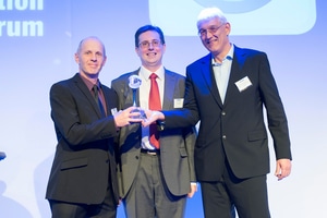 Liebherr's representatives Max Kenzelmann and Roland Bohnacker(far left and right) receives the design award from KHL Group's Chris Sleight (centre) (Photo: Hans Dhillon)