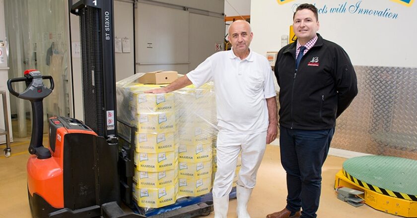Hellenic Cheese’s Jim Konas and TMHA’s Adem Shemshedin with the Toyota BT Staxio SWE120S walkie stacker forklift.