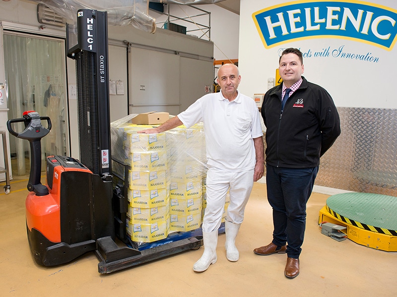 Hellenic Cheese’s Jim Konas and TMHA’s Adem Shemshedin with the Toyota BT Staxio SWE120S walkie stacker forklift.